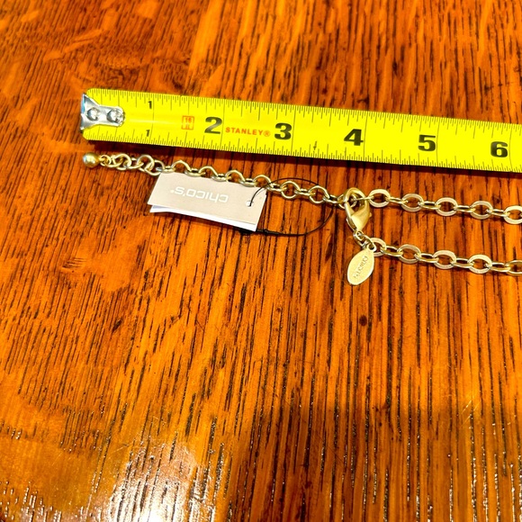 Chico’s 34 in charm necklace tag still attached. Charms include heart, star, etc - Picture 6 of 7